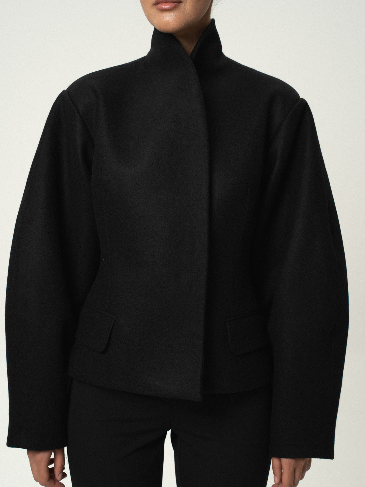 Fitted balloon-sleeve wool jacket in black, close front view